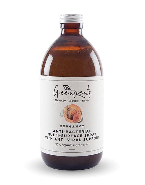 An reusable and refillable amber glass bottle of Greenscents Bergamot Anti-Bacterial Multi-Surface Spray with a white label and silver cap, shown on a white background.