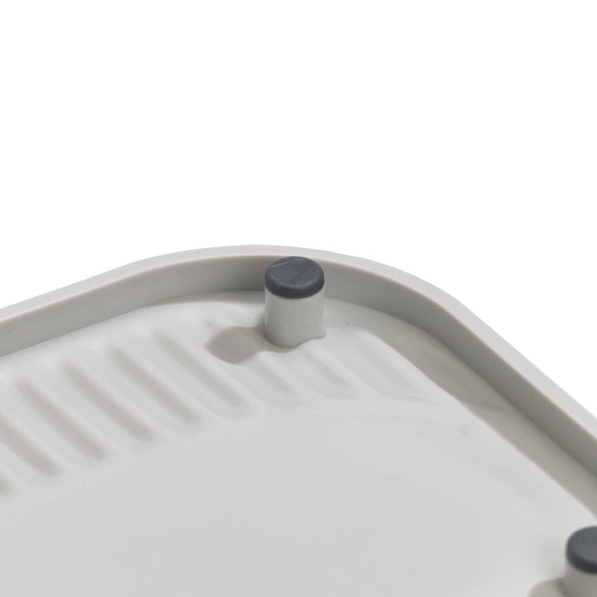 Close-up of a gray grill pan with a lid on a white background