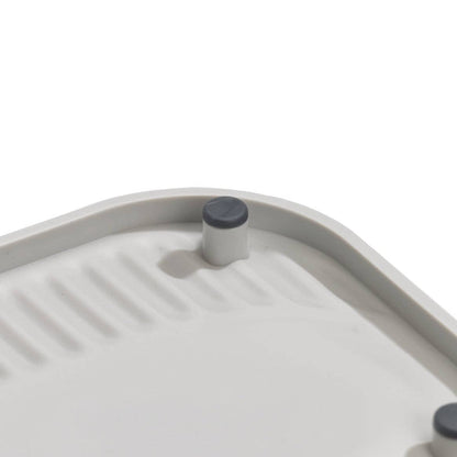 Close-up of a gray grill pan with a lid on a white background
