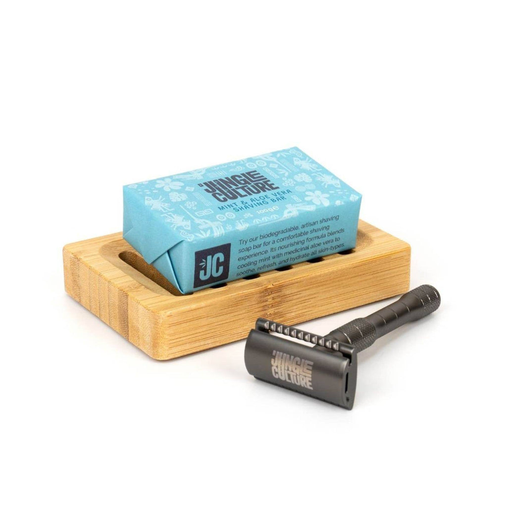 blue packaging of soap on bamboo soap tray with black razor entitled Jungle Culture 