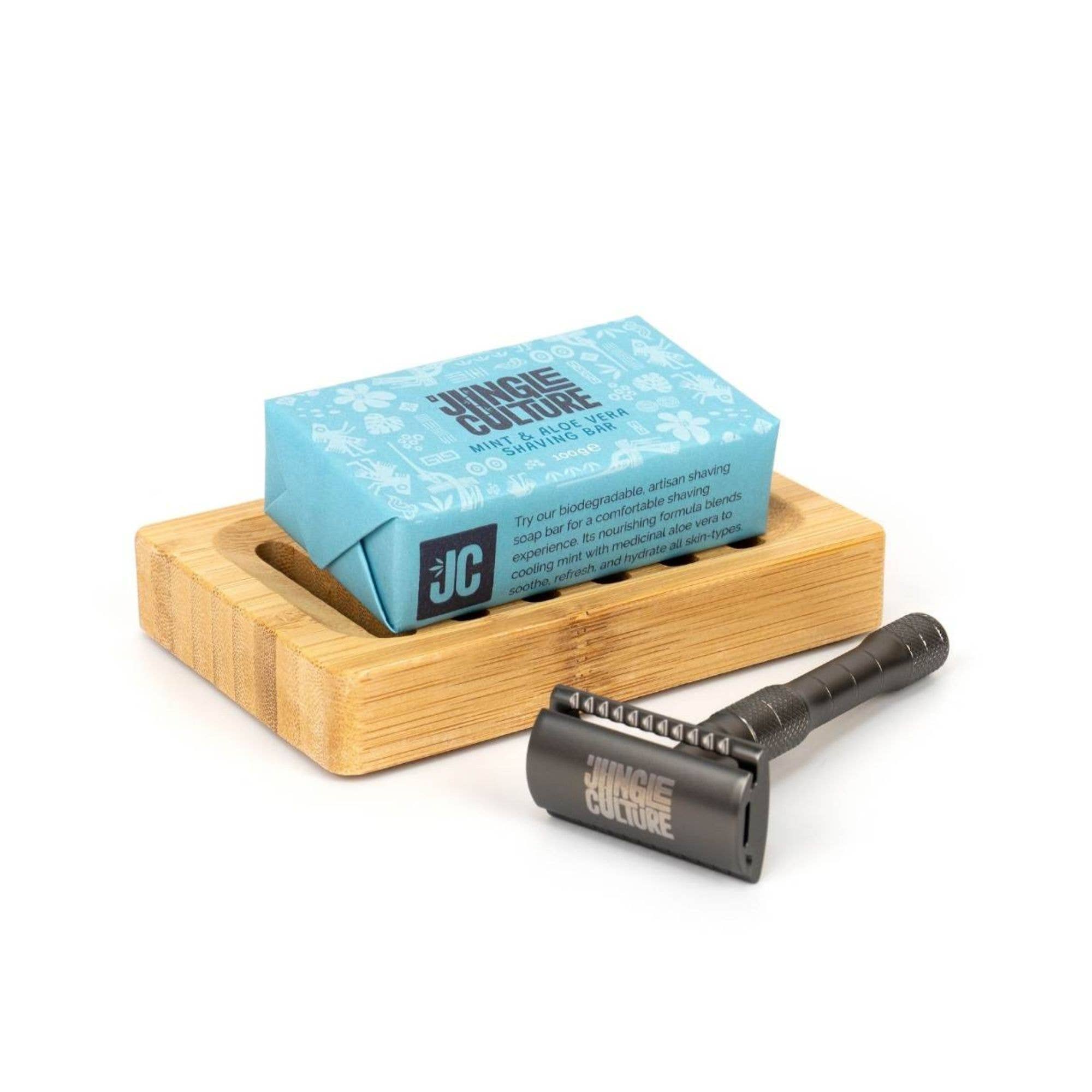 blue packaging of soap on bamboo soap tray with black razor entitled Jungle Culture 