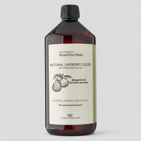 Bottle of natural laundry liquid with a label on a white background