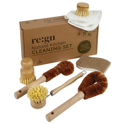 A natural kitchen cleaning set displayed with its brown cardboard packaging box on a white background. The set includes multiple wooden-handled cleaning brushes and a sponge, with one brush showing natural tan bristles and another showing white fabric washcloths.