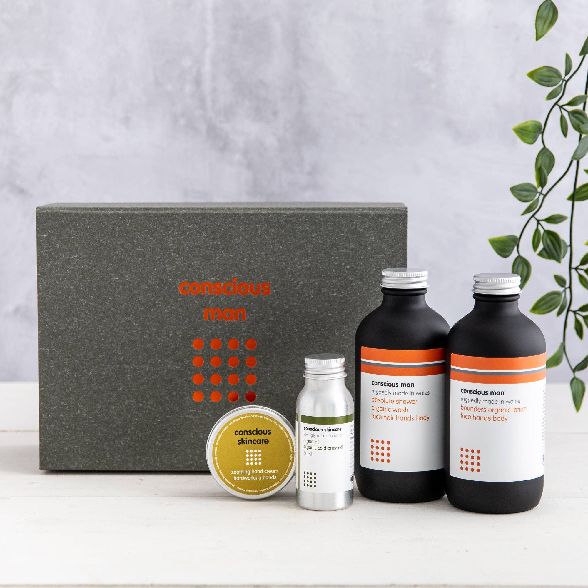 Set of skincare products with 'conscious man' branding on a neutral background