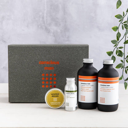 Set of skincare products with 'conscious man' branding on a neutral background